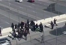 Photo of White Supremacists Group Forced to Retreat from Highway Overpass After Black Residents Drive Them Out, Burn Racist Flag